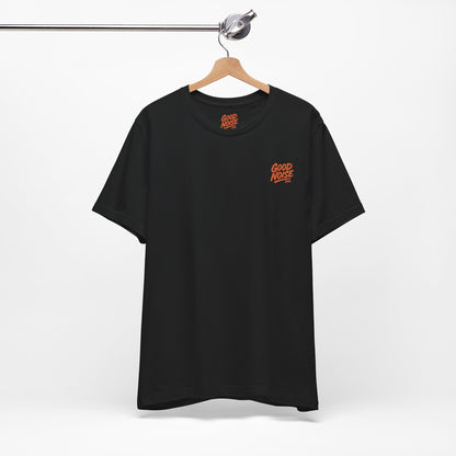 Black t-shirt with orange logo on a hanger against a white background